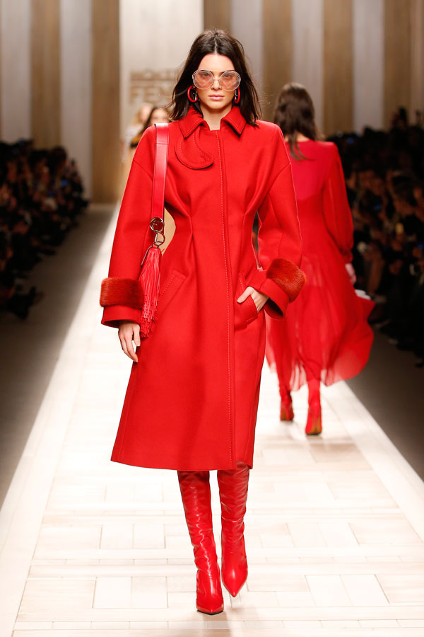 A model, sunglasses detail, walks the runway at the Fendi show